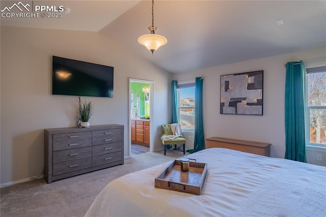 bedroom with carpet, vaulted ceiling, and ensuite bathroom