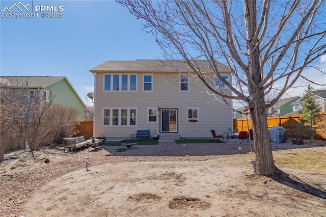 back of property featuring a patio area and fence