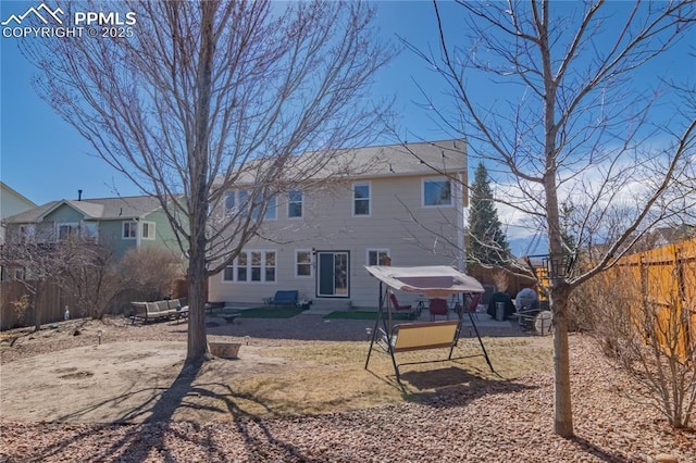 rear view of house featuring entry steps, a patio area, and a fenced backyard