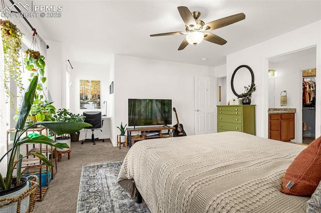 carpeted bedroom with ceiling fan and ensuite bathroom