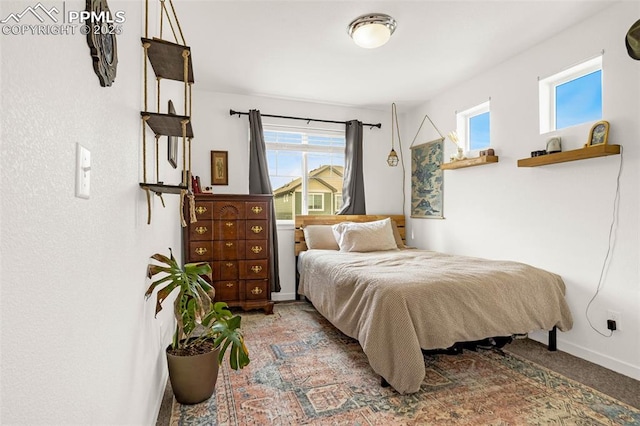 carpeted bedroom featuring baseboards