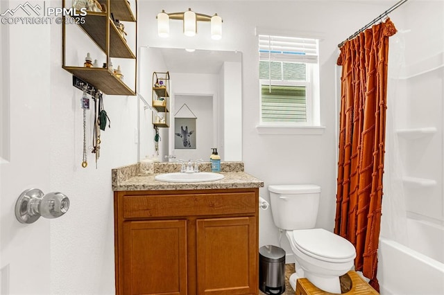 bathroom with shower / bath combo with shower curtain, vanity, and toilet