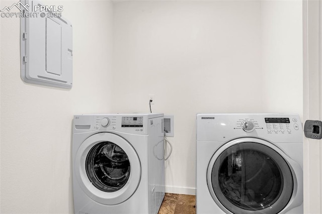 washroom featuring laundry area, washing machine and dryer, and electric panel