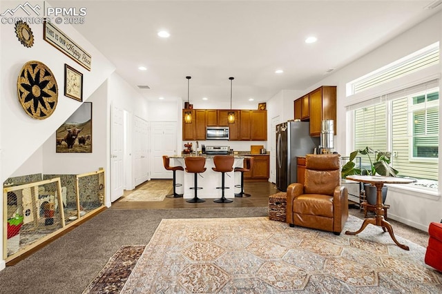 living area featuring recessed lighting, visible vents, and baseboards