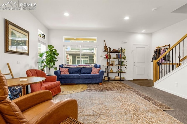 carpeted living area featuring baseboards, stairway, and recessed lighting