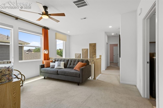 living area featuring a ceiling fan, light colored carpet, visible vents, and recessed lighting