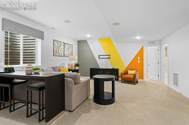 carpeted living area with recessed lighting, visible vents, and baseboards