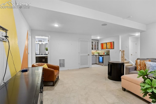 living room featuring recessed lighting, visible vents, and light colored carpet