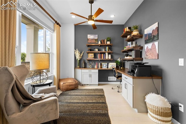 home office featuring built in desk, recessed lighting, a ceiling fan, and light wood-style floors