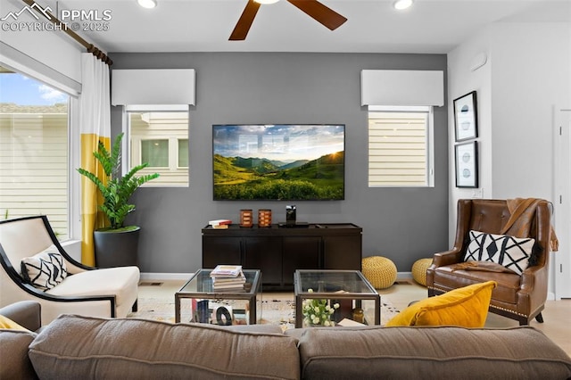 living area featuring baseboards, a ceiling fan, and recessed lighting