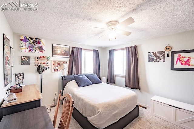 bedroom featuring carpet flooring, a ceiling fan, visible vents, and a textured ceiling