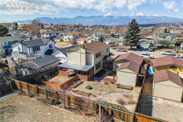 birds eye view of property with a mountain view and a residential view