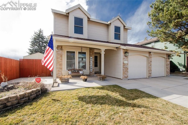 traditional-style house featuring a front yard, fence, a porch, an attached garage, and concrete driveway