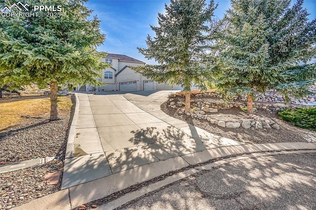 view of front of house with a garage, concrete driveway, and stucco siding