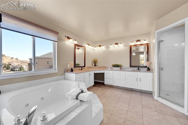 bathroom with a whirlpool tub, a stall shower, vanity, and tile patterned floors