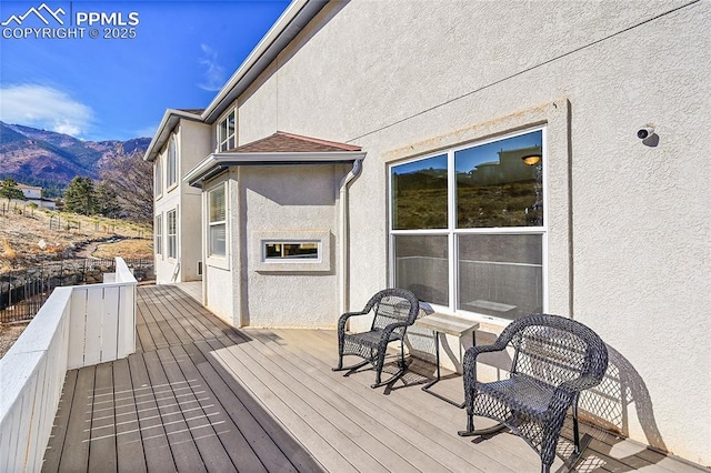 wooden terrace featuring a mountain view