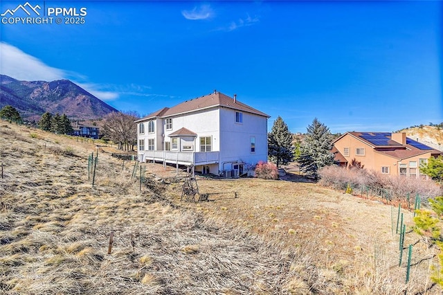 rear view of property with a mountain view