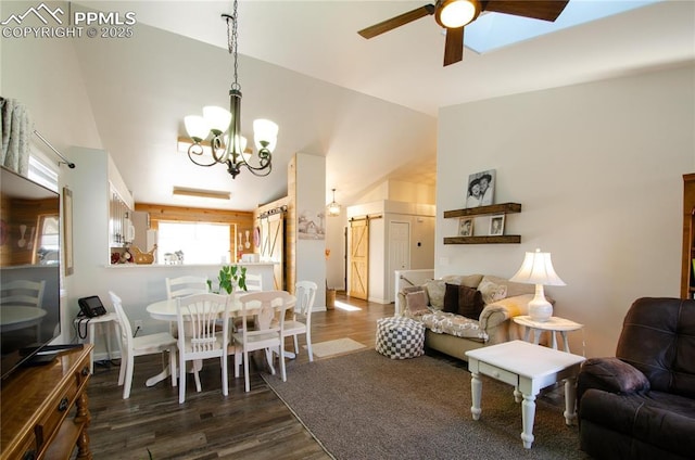 dining room featuring ceiling fan with notable chandelier, high vaulted ceiling, a barn door, and wood finished floors