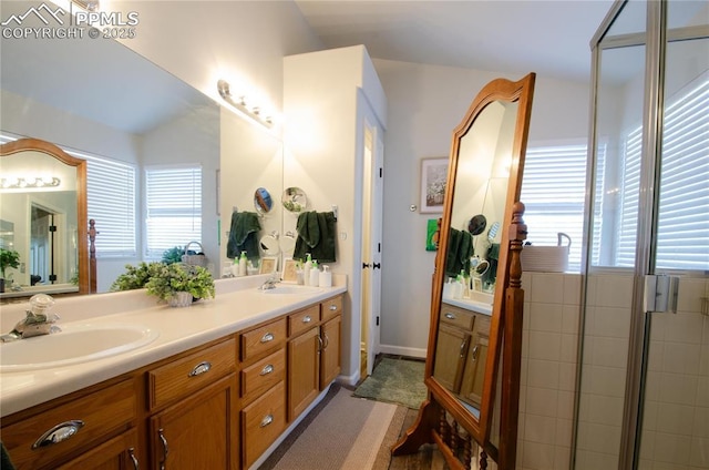 full bathroom with double vanity, plenty of natural light, and a sink