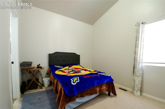 bedroom featuring baseboards, visible vents, lofted ceiling, and carpet floors