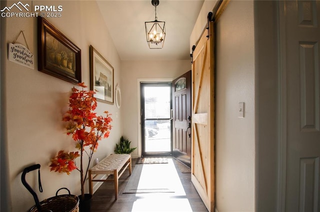 entryway featuring a barn door and dark wood-style flooring