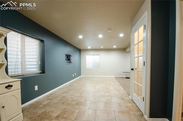 empty room featuring recessed lighting and baseboards