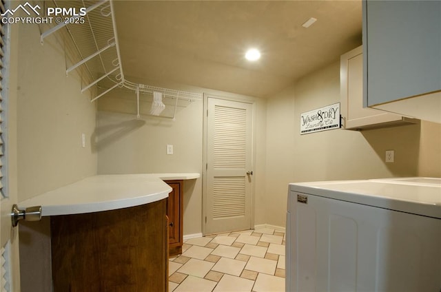 washroom with washer / dryer, recessed lighting, cabinet space, and baseboards