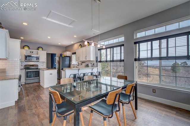 dining area featuring dark wood-style flooring, recessed lighting, and baseboards