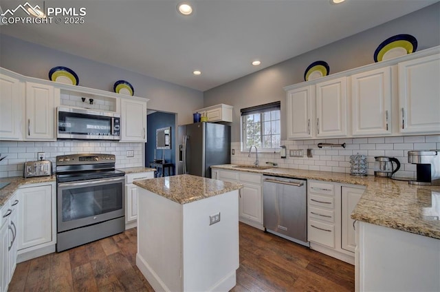 kitchen with white cabinetry, appliances with stainless steel finishes, dark wood finished floors, and a sink