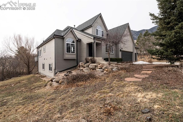 view of front of property featuring brick siding and an attached garage