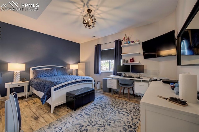 bedroom with light wood-type flooring and visible vents