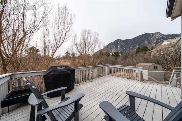 wooden deck featuring a mountain view and grilling area