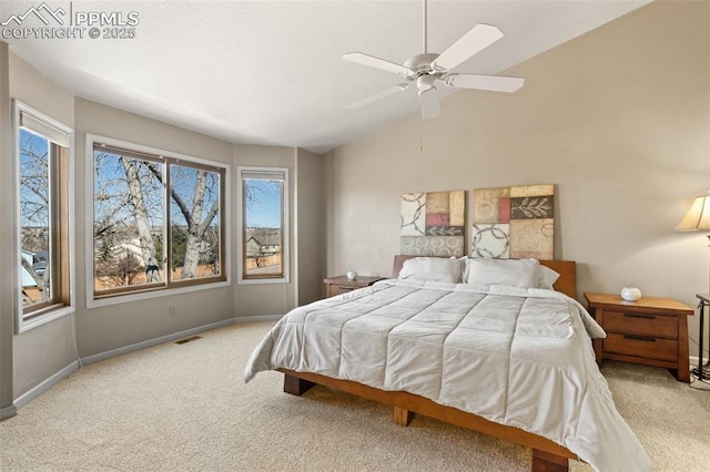 carpeted bedroom featuring baseboards, visible vents, vaulted ceiling, and a ceiling fan