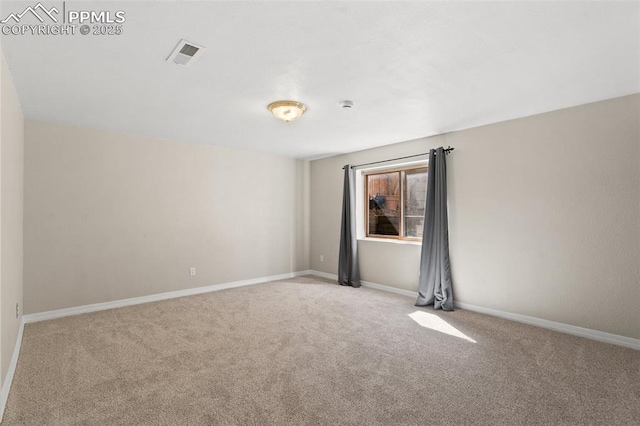 carpeted empty room featuring visible vents and baseboards