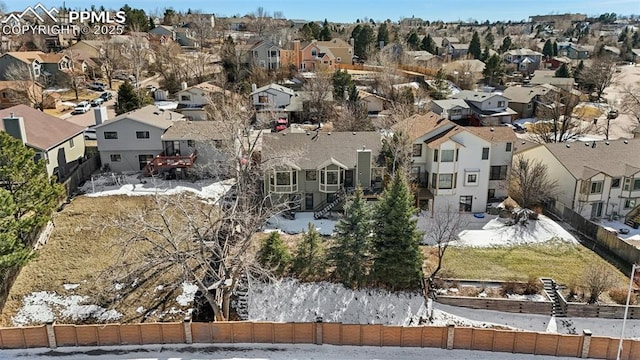 snowy aerial view with a residential view