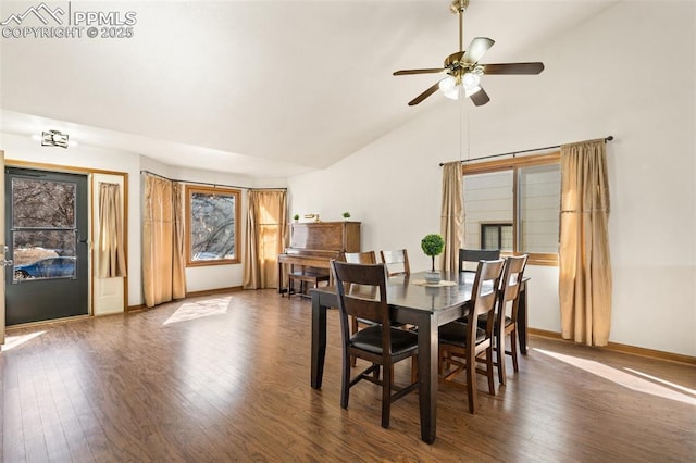 dining area featuring a ceiling fan, vaulted ceiling, baseboards, and wood finished floors