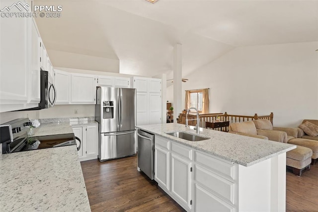 kitchen with vaulted ceiling, appliances with stainless steel finishes, a sink, and white cabinetry