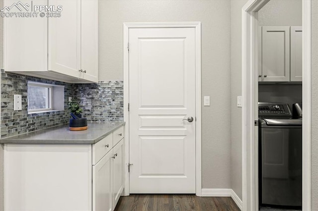 kitchen featuring tasteful backsplash, dark wood finished floors, white cabinetry, baseboards, and washer / dryer