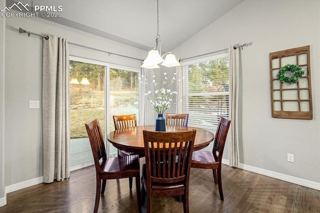 dining space with an inviting chandelier, lofted ceiling, baseboards, and dark wood-style flooring