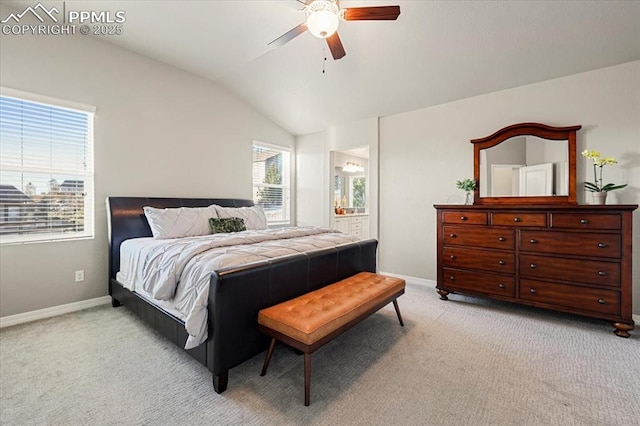 bedroom with vaulted ceiling, baseboards, and light carpet