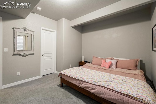 bedroom with baseboards and carpet floors