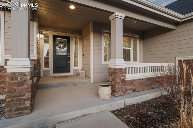 view of exterior entry featuring a porch