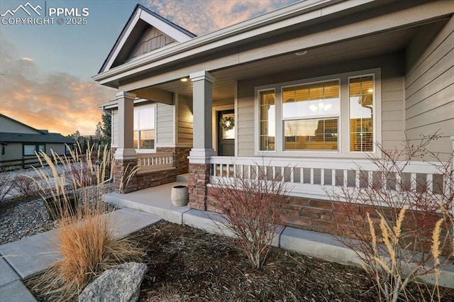 entrance to property featuring a porch and board and batten siding