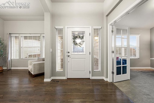 entryway featuring baseboards and wood finished floors