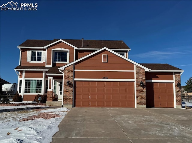 view of front of property with a garage, concrete driveway, and brick siding