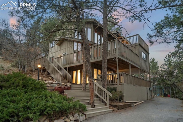 view of front of property with a deck and stairway