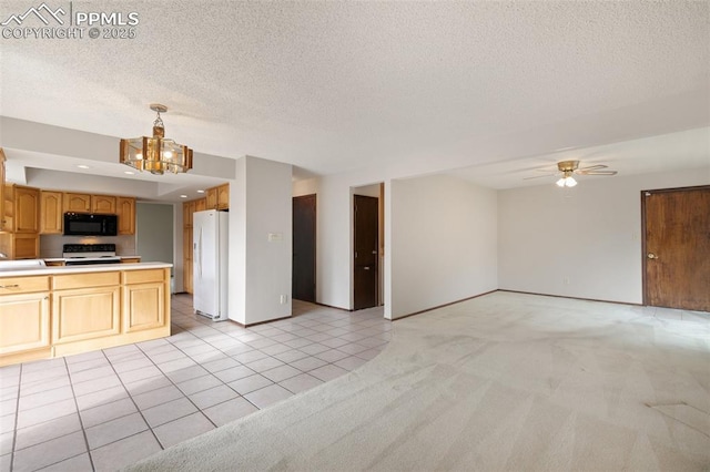 kitchen featuring black microwave, light carpet, electric range, open floor plan, and freestanding refrigerator