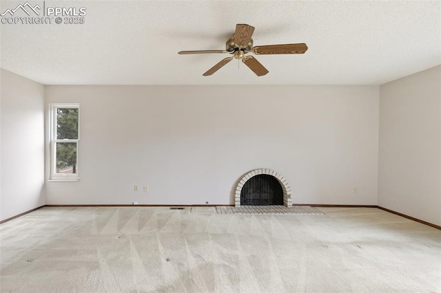 unfurnished living room featuring carpet floors, a fireplace, baseboards, and ceiling fan