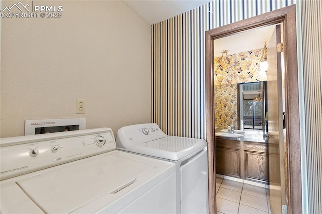 clothes washing area featuring laundry area, light tile patterned flooring, wallpapered walls, and independent washer and dryer