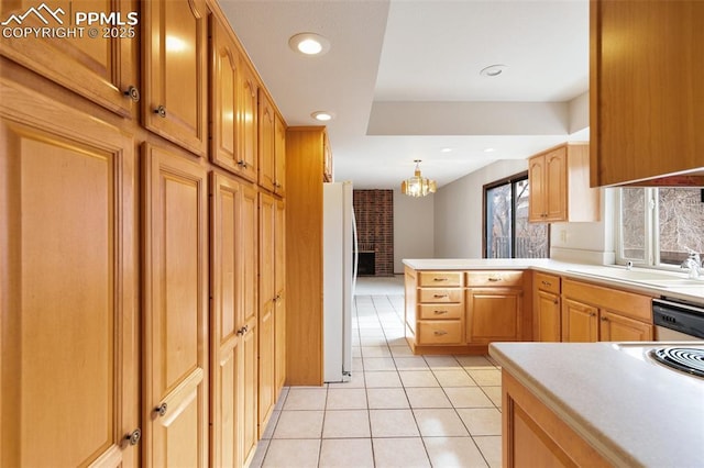 kitchen featuring light tile patterned floors, recessed lighting, a peninsula, stainless steel dishwasher, and freestanding refrigerator